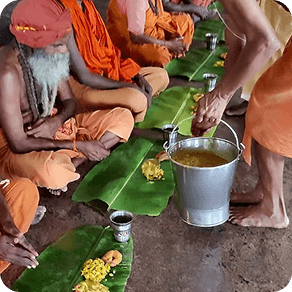 Devotees sharing Annadhanam on banana leaves